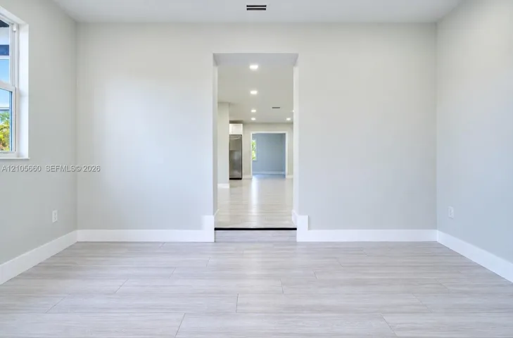 Interior space featuring wood-finish flooring, neutral wall tones, and recessed lighting