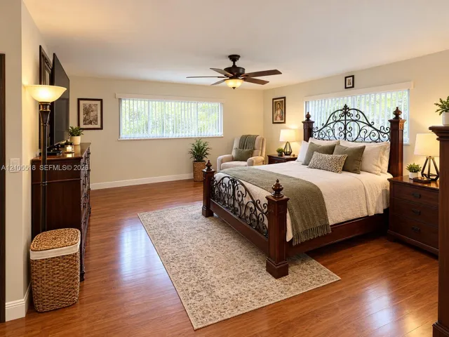 Expansive room featuring wood-finish flooring, horizontal blinds, and an integrated ceiling fan