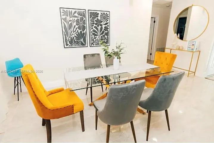 Large-format polished tile flooring throughout