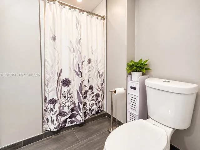 A first floor full bathroom next to a bedroom provide flexibility for guests, family, or a home office