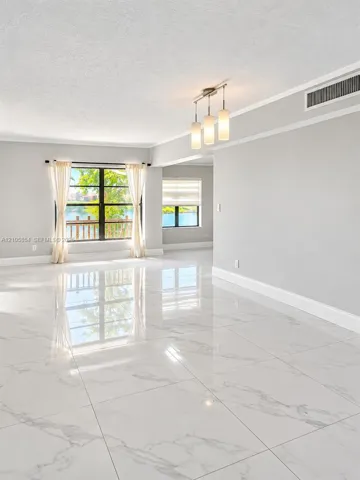 Edited image showing how the room would look without furniture, highlighting its spacious layout, beautiful flooring and stunning lake view.