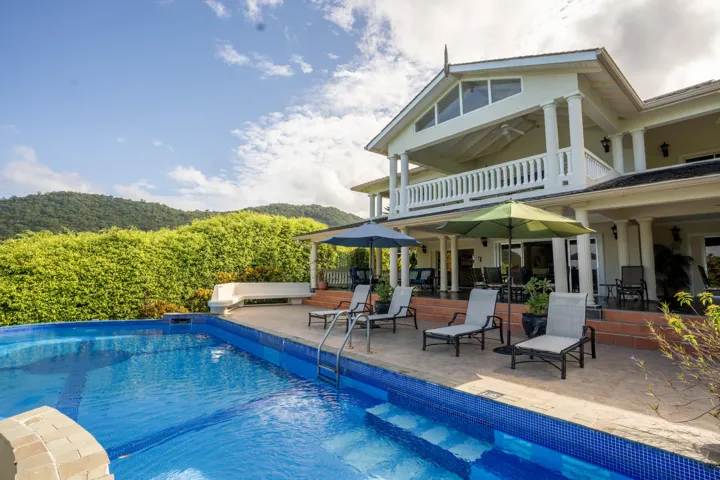 Beautiful villa overlooking a sparkling pool and tropical surroundings.