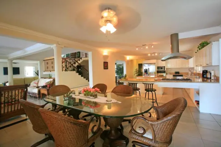 Inviting dining space with a large table and warm interior finishes.