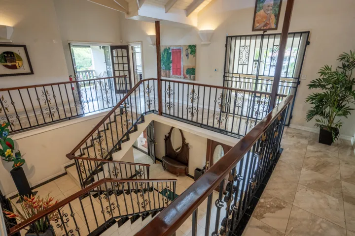 Beautiful staircase with decorative railings overlooking the lower level.