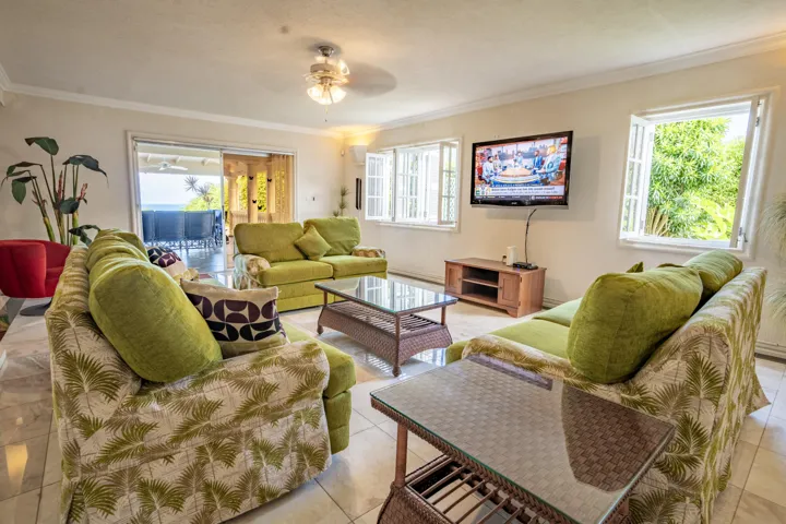 Charming sitting area with elegant furnishings and tropical accents.