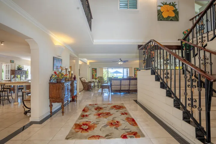 Welcoming interior featuring an elegant staircase and spacious entryway.