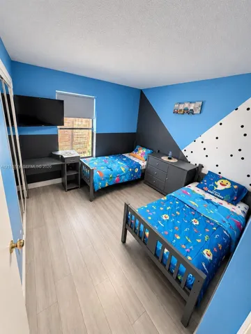 Wood-finish flooring and a closet with sliding mirrored doors