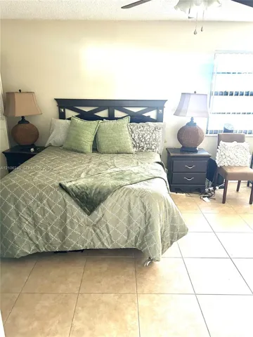 Ceramic tile flooring, horizontal window with integrated blinds, and ceiling fan with integrated lighting