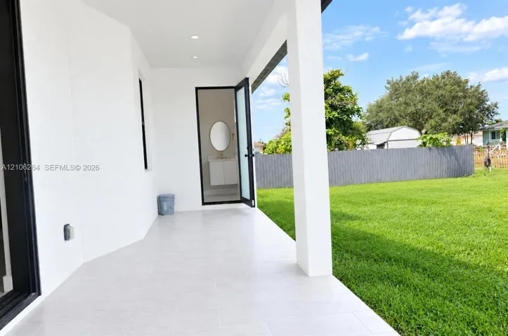 Covered patio featuring light-toned tile flooring, recessed lighting, and a direct entrance to an interior space