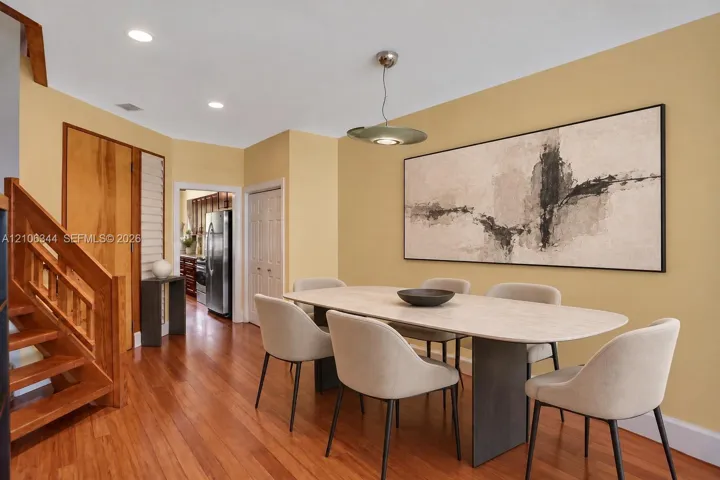 Interior featuring wood-finish flooring, recessed lighting, and a custom wood staircase with matching railing