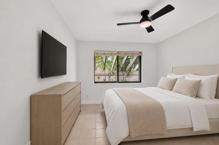Calm guest bedroom with wall-mounted TV