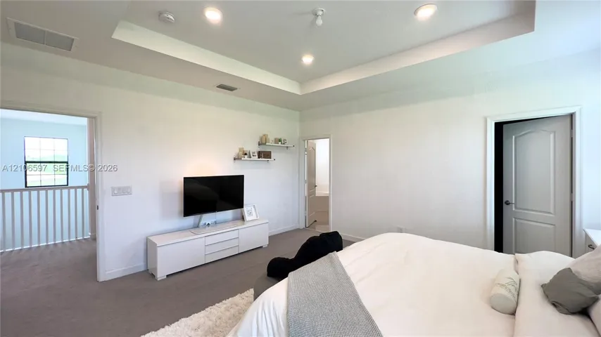 Tray ceiling featuring recessed lighting and wall-to-wall carpeting