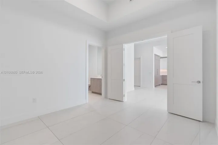 Tray ceiling, large-format tile flooring, and Shaker-style interior doors