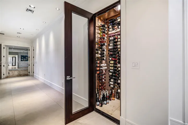 300-bottle, climate-controlled wine storage featuring a wood-finish door with glass inset, structured metal racking, and recessed interior lighting