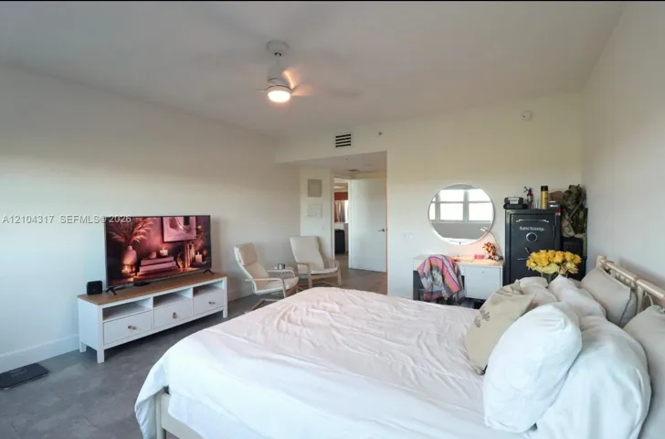 Neutral-toned interior featuring tiled flooring and a ceiling-mounted light fixture with a fan