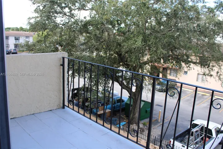 Private balcony featuring tiled flooring and a decorative wrought iron railing