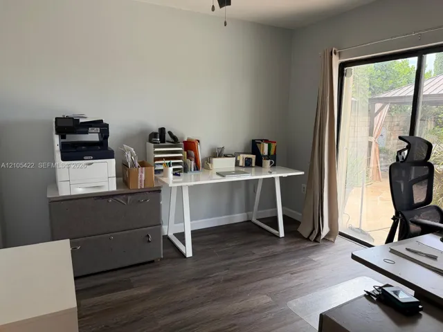 Room featuring wood-finish flooring and a sliding glass door providing access to an outdoor patio
