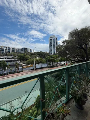 Balcony featuring decorative metal railings and tile flooring