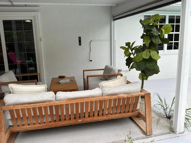 Covered patio featuring a concrete floor, stucco wall finish, and white-framed glass paneled door and window