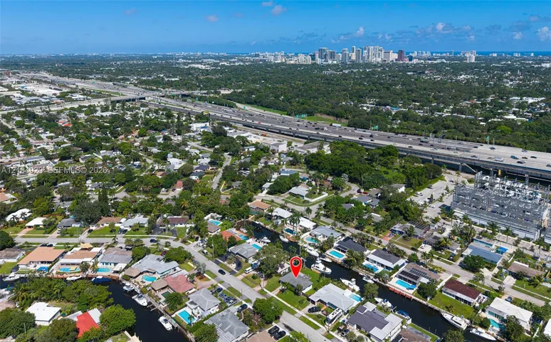 Waterfront showing property featuring direct canal access, a private boat slip, and mature landscaping