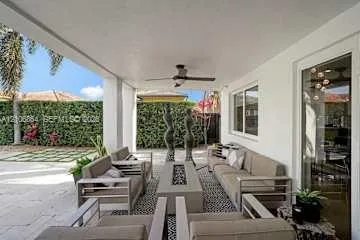 Covered outdoor living space featuring a smooth ceiling, recessed lighting, a ceiling fan, and stone-finish flooring