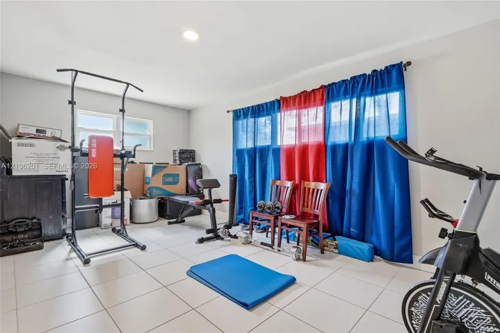 Room featuring ceramic tile flooring, neutral wall paint, and recessed lighting, with windows providing natural light