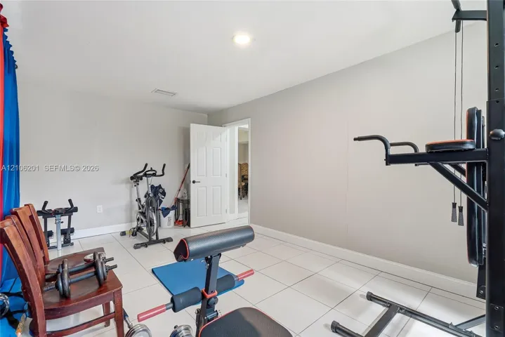 Room featuring large-format ceramic tile flooring, neutral wall paint, and recessed ceiling lighting