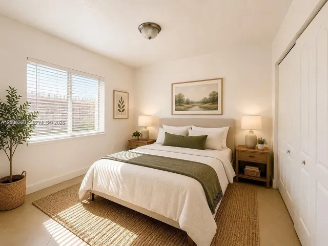 Neutral interior featuring large-format tile flooring, double-door closet, and dual-pane window with horizontal blinds