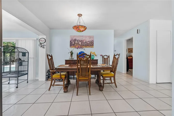 Dining area featuring tile flooring and a decorative stained-glass pendant light fixture