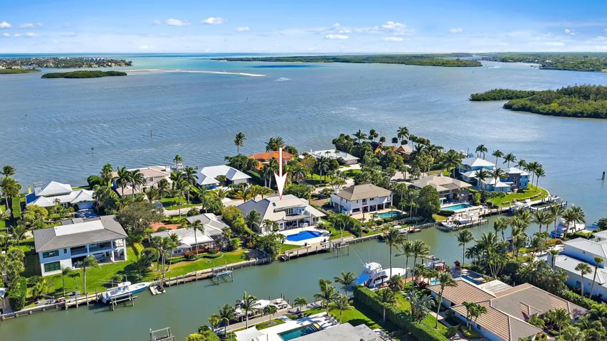 Waterfront property featuring a private boat dock, swimming pool, and direct canal access