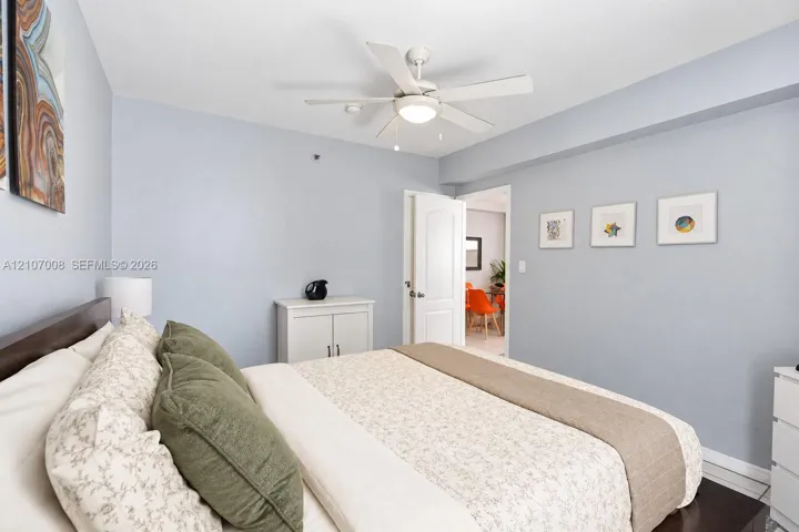 Room featuring a ceiling fan with integrated lighting and a multi-panel door
