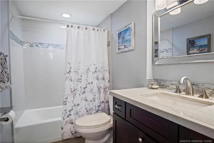 2nd Full Bath - Upgraded Tile Surround with Inlay, Vanity, Mirror and Lighting