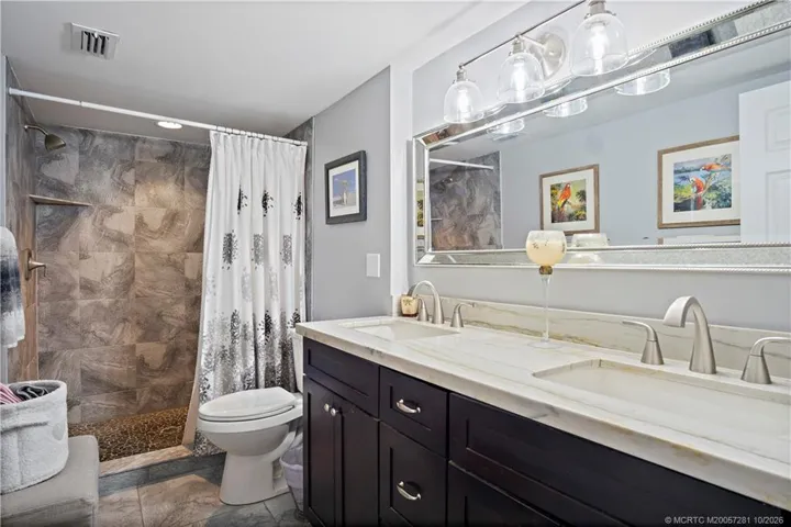 Larger Custom Tiled Walk-in Shower, Double Vanity, Upgraded Mirror and Lighting. Tiled Floors