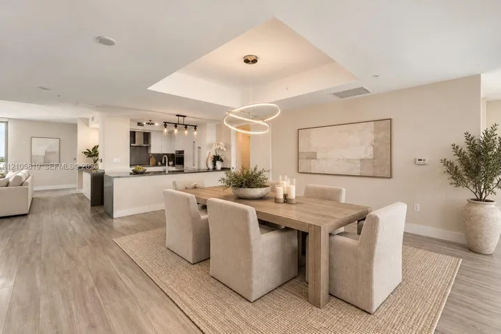 Open-concept Dining Room featuring a tray ceiling.