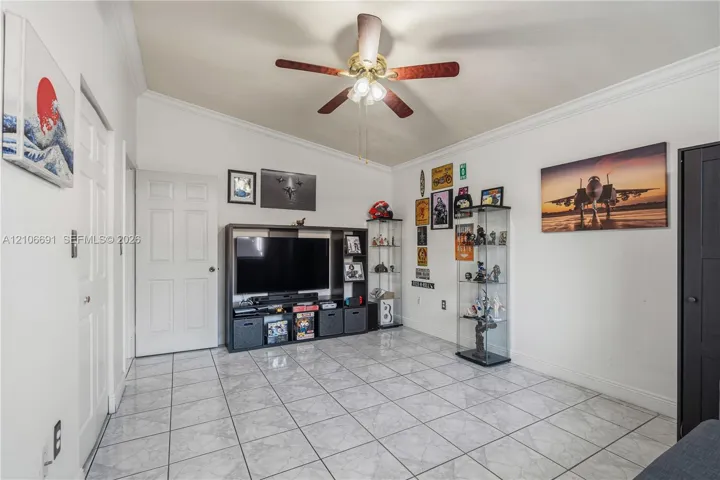 Vaulted ceiling featuring a central multi-blade light fixture and ceramic tile flooring