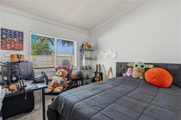 Room interior featuring tile flooring, crown molding, and a horizontal window with horizontal blinds