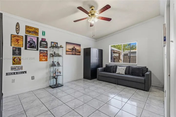 Spacious living area featuring tile flooring, recessed lighting, and a ceiling fan with integrated light fixture