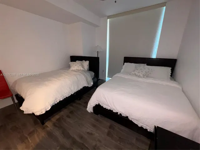 Wood-finish flooring and floor-to-ceiling window covering
