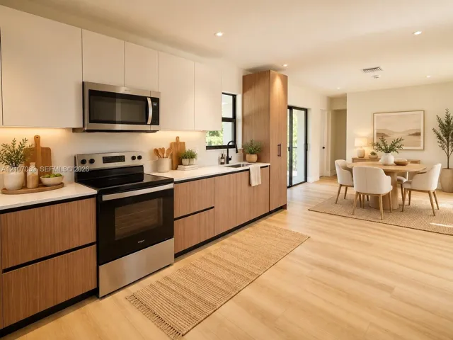 Kitchen featuring two-tone cabinetry, wood-finish flooring, recessed lighting, stainless steel appliances, and integrated under-cabinet lighting