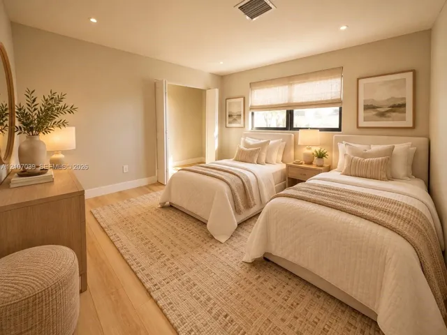 Neutral-toned interior featuring wood-finish flooring, recessed lighting, and a window with integrated shade treatments