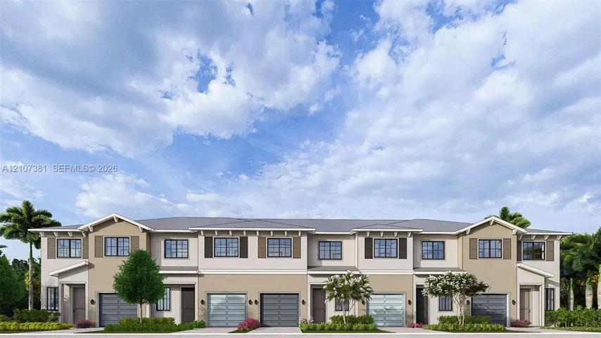 Multi-unit residential exterior featuring a multi-tone stucco facade, gabled rooflines, decorative shutters, and individual multi-panel garage doors