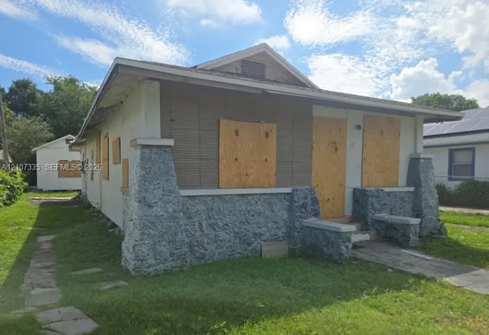 Single-story bungalow featuring a covered front porch, stone-veneer foundation, and gable roof