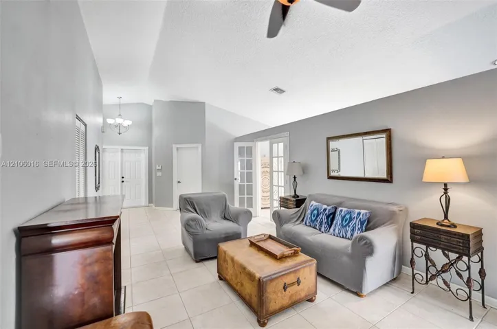 Vaulted ceilings, ceramic tile flooring, French doors with glass panes, and double entry doors