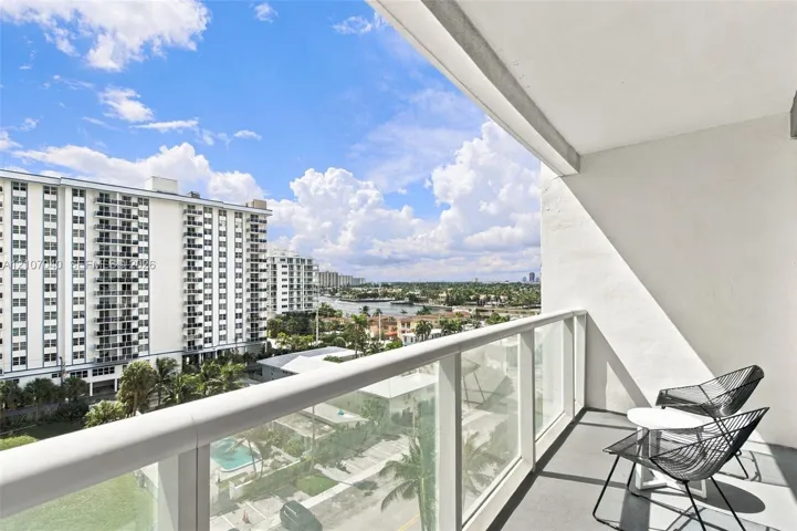 Private balcony featuring a glass-panel railing and concrete​​‌​​​​‌​​‌‌​‌‌​​​‌‌​‌​‌​‌​​​‌​​ flooring