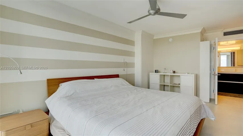 Interior room featuring crown molding, a multi-blade ceiling fan, and large-format tile flooring
