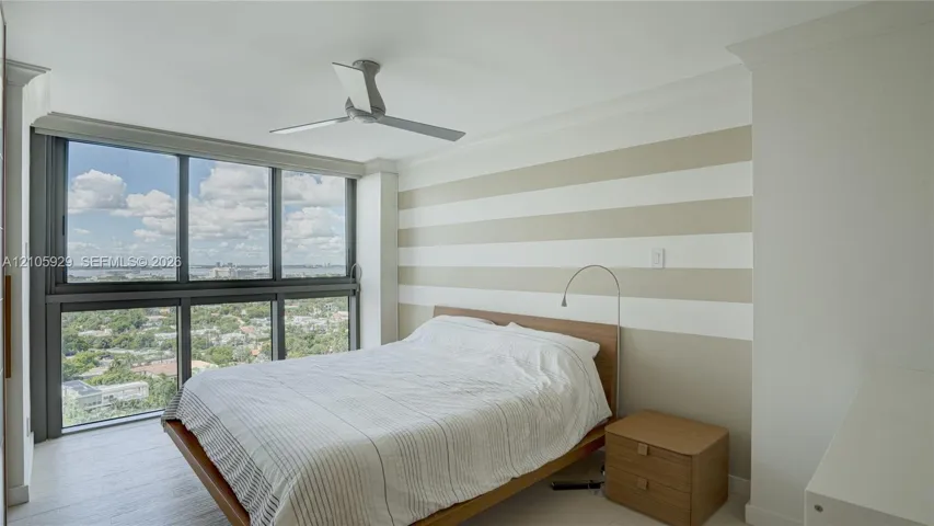 Floor-to-ceiling windows, wood-finish flooring, ceiling fan, and crown molding
