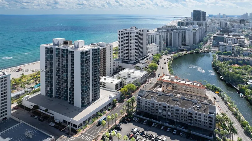 High-rise residential building featuring floor-to-ceiling glass windows, balconies, proximity to the coastline, and waterfront positioning