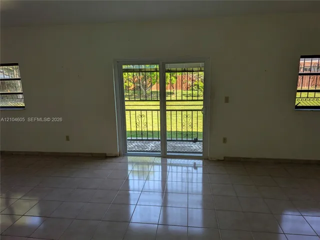 Ceramic tile flooring, sliding glass patio door, and exterior metal security grilles installed on all windows and door