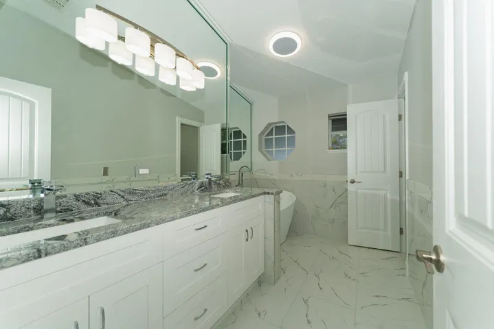 Two sinks in the main bathroom with custom cabinetry