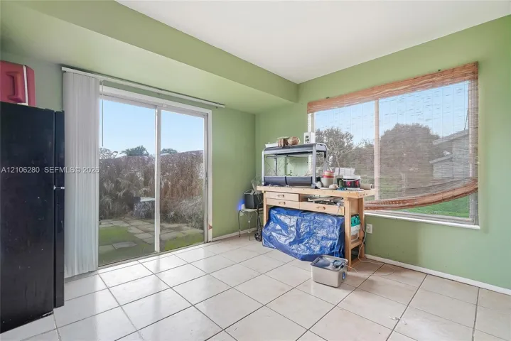 Ceramic tile flooring, sliding glass door, and large picture window